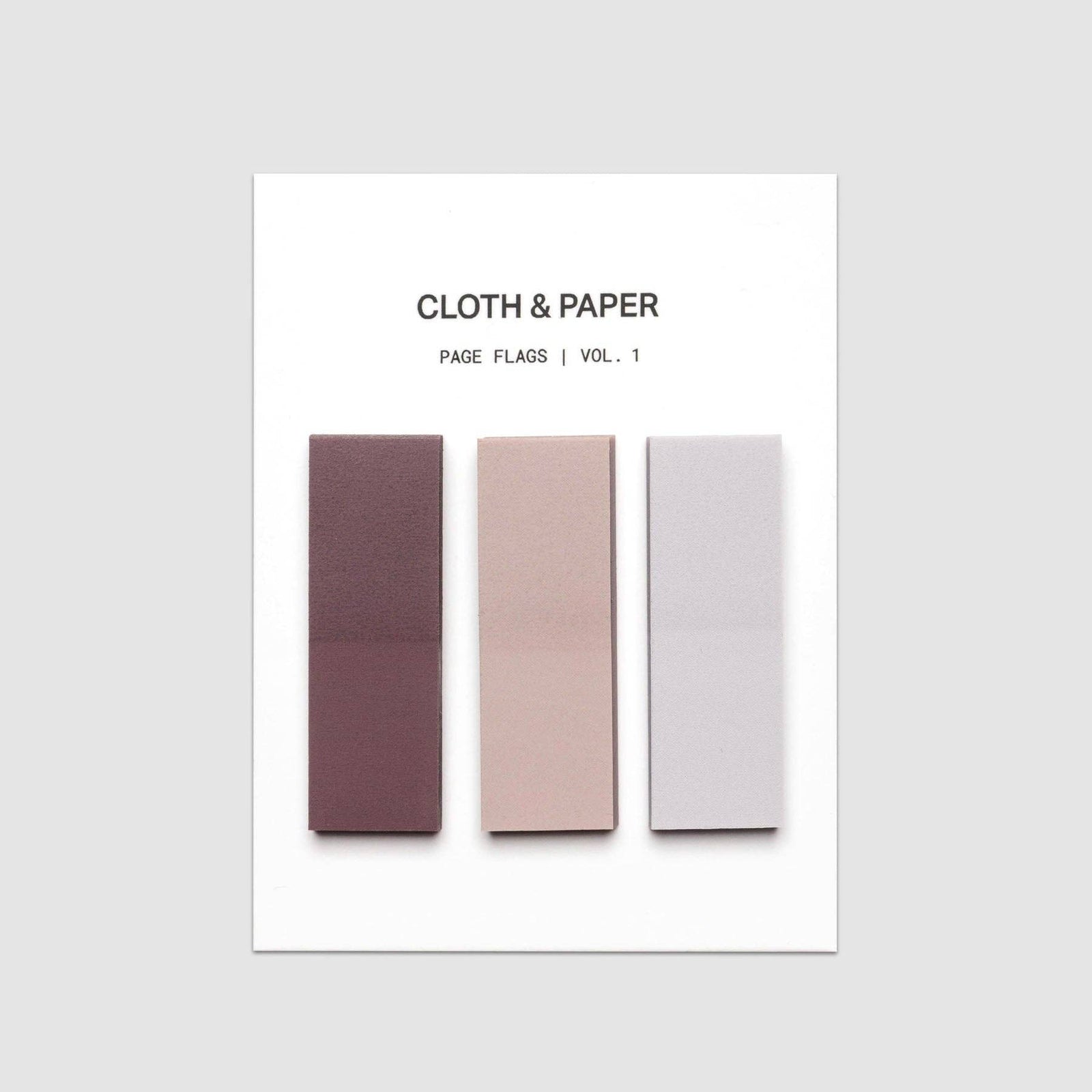 A white card titled 'CLOTH & PAPER' with three vertical rectangular fabric swatches in muted plum, blush, and pale gray, shown on a light gray background.