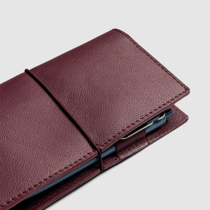Brown leather phone case on a light gray background
