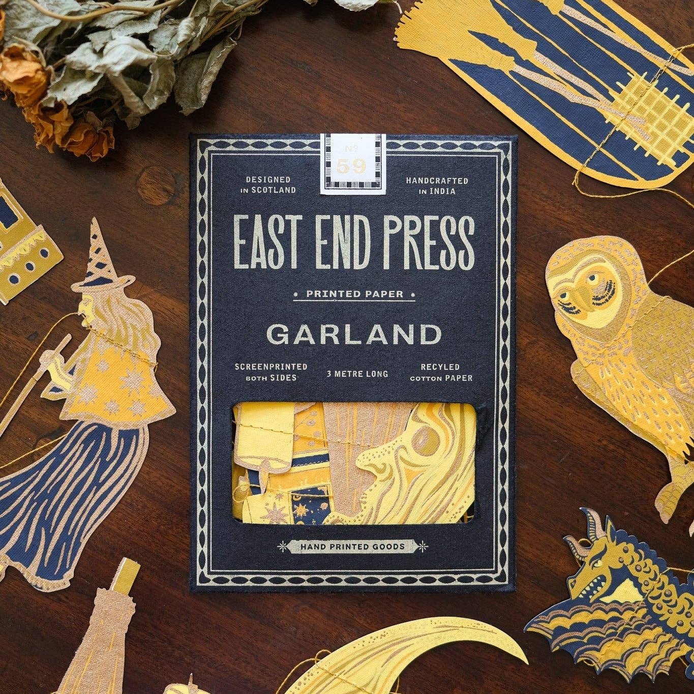 East End Press Garland packaging on a wooden surface with decorative items.