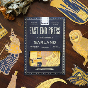 East End Press Garland packaging on a wooden surface with decorative items.