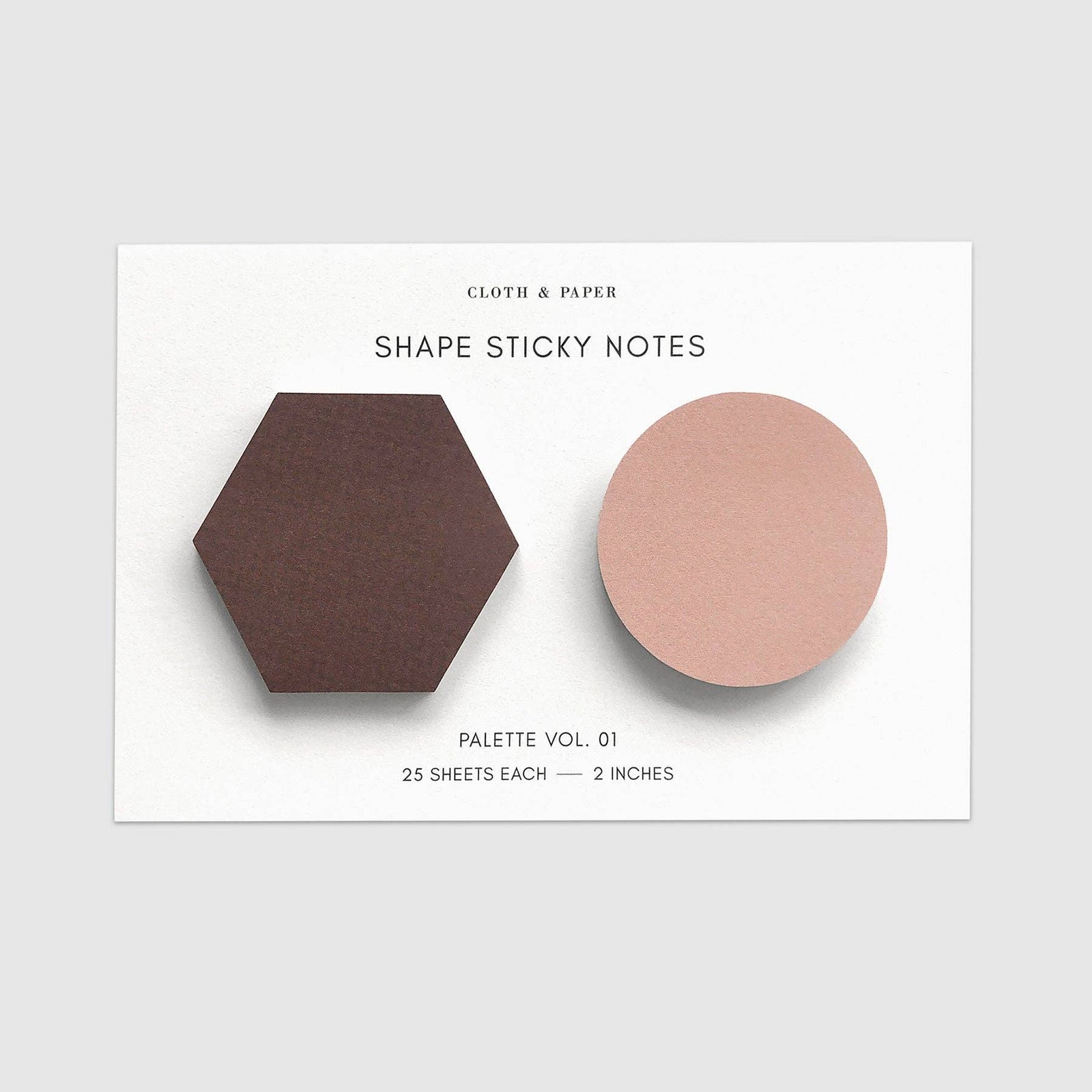 Two geometric sticky notes, one hexagonal and one circular, on a white card with text.
