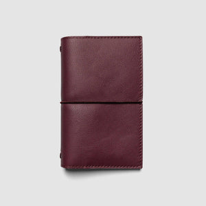 Burgundy leather wallet on a light gray background