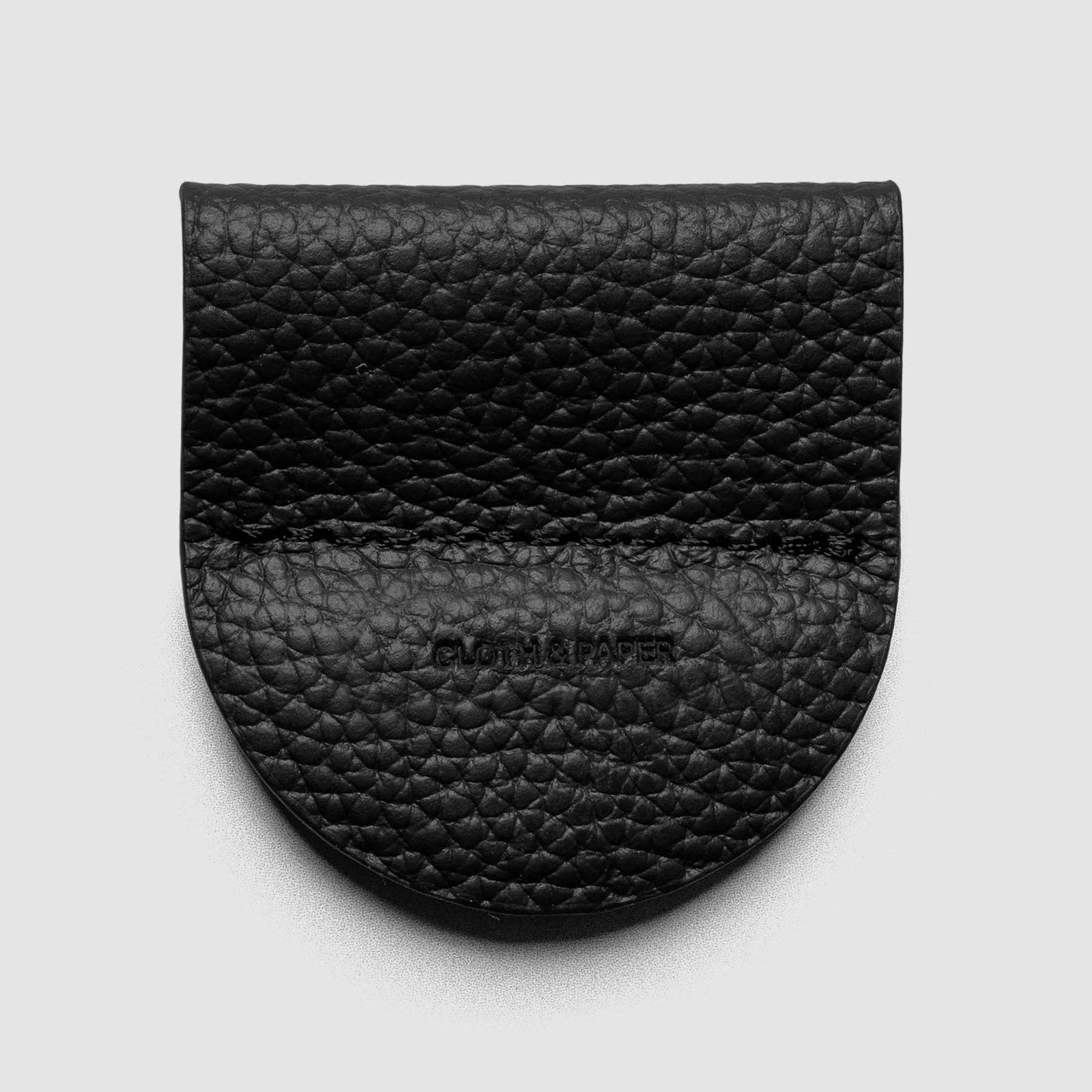 A burgundy pebbled leather card holder or wallet with a rounded bottom edge and a stitched seam, featuring the embossed brand name 'CLOTHING' in the center, shown on a light gray background.