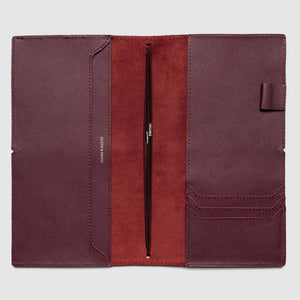 Open leather wallet with pen on a light gray background
